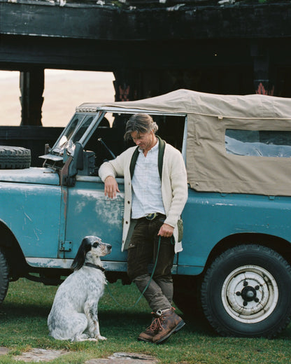 The Heroes Cardigan combines timeless style with premium Norwegian wool craftsmanship. Knitted from 100% Norwegian wool, this versatile cardigan offers natural warmth and breathability, making it ideal for layering during changing weather conditions. Refined waxed cotton details add classic outdoor styling while providing subtle weather resistance. Whether worn as a sophisticated mid-layer on mountain adventures or as a standalone piece for casual occasions, this cardigan delivers the perfect balance of com