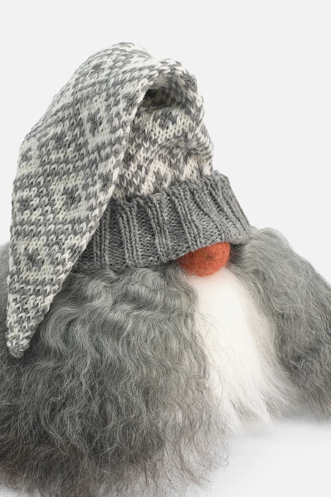 Gnome with a knitted hat and orange nose on a white background