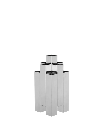 The Tessera Vase brings sculptural character to the home with its striking architectural form. Crafted from mirror-polished stainless steel, it catches and reflects light, adding a dynamic presence to a shelf, dining table, or sideboard. Designed to hold floral arrangements or stand alone as an object in its own right, the vase offers a thoughtful balance of form and function.