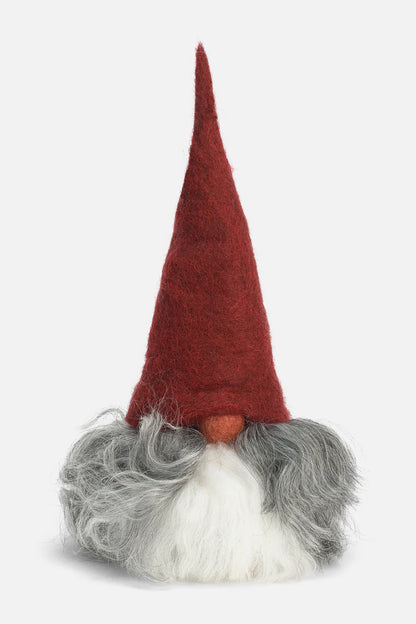 Gnome figurine with a red hat, gray beard, and white mustache on a light gray background