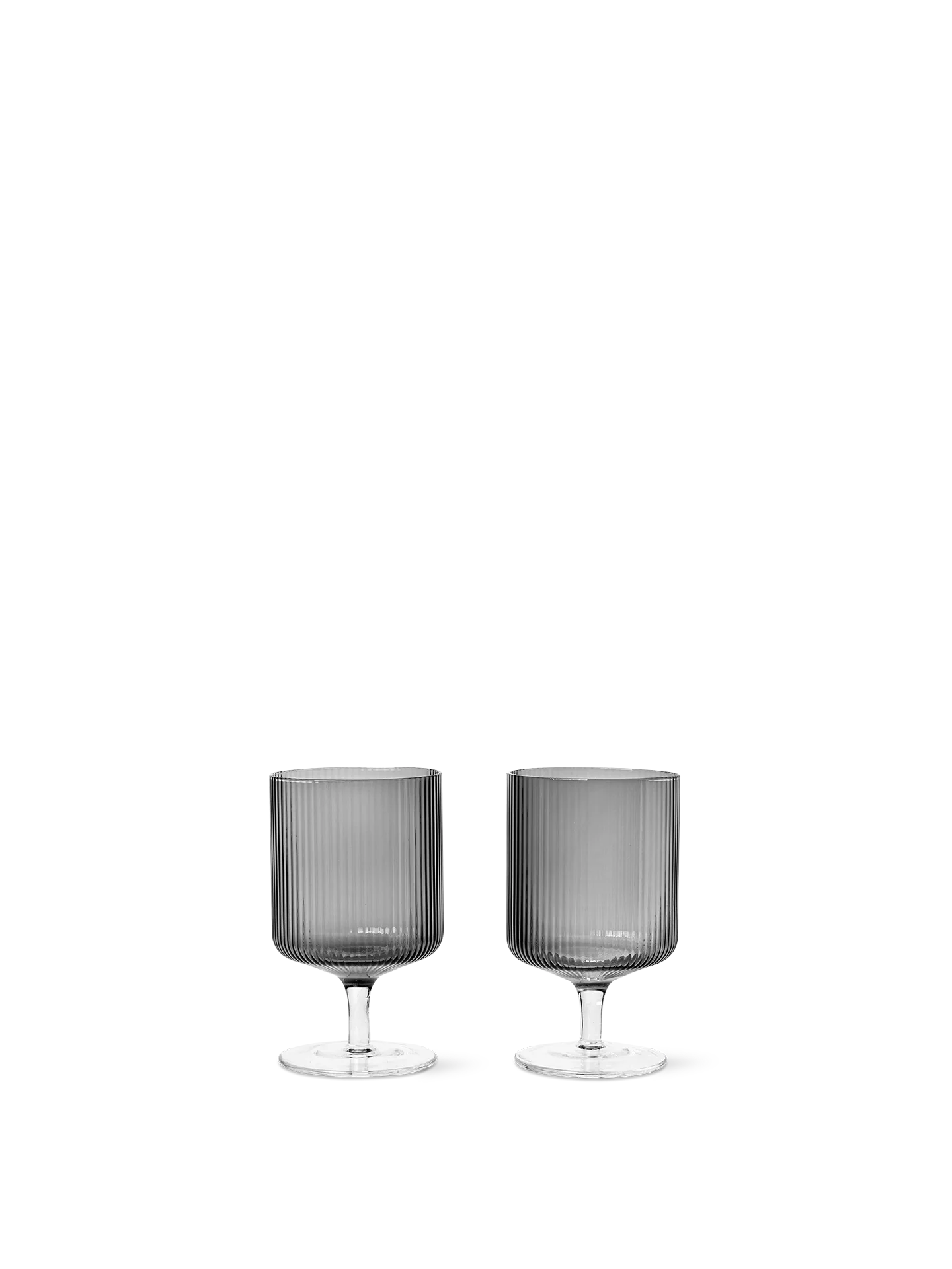 For a casual drink in the garden, the large dinner party or as the fancy supplement at brunch, the Ripple Wine Glass will complete any setting with its unique expression. Mouth-blown into the shape the wine glasses feature the series' characteristic rippled surface and geometric silhouette, making the set of two glasses stack able. Pair the glasses with the rest of the Ripple series and serve your favorite beverage in style.