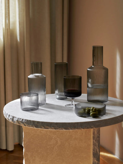 For a casual drink in the garden, the large dinner party or as the fancy supplement at brunch, the Ripple Wine Glass will complete any setting with its unique expression. Mouth-blown into the shape the wine glasses feature the series' characteristic rippled surface and geometric silhouette, making the set of two glasses stack able. Pair the glasses with the rest of the Ripple series and serve your favorite beverage in style.