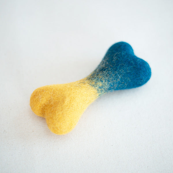 Bone-shaped object with blue and yellow gradient on a white background
